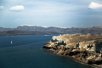 Scenic view of sea and mountains against sky