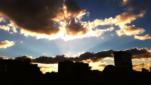 Low angle view of silhouette buildings against sky during sunset