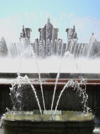 Close-up of fountain splashing against sky
