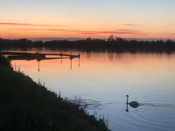 Scenic view of lake against sky during sunset