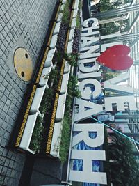 Low angle view of text on street against buildings