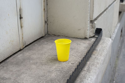 Close-up of yellow pipe on wall