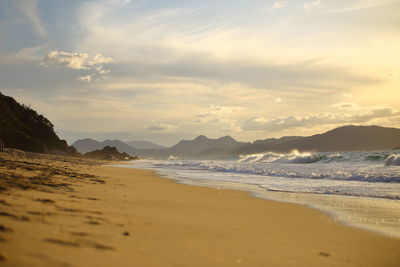 Scenic view of beach against sky during sunset