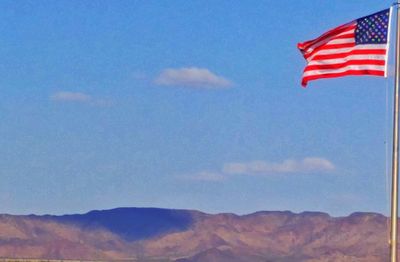 Low angle view of red wall against blue sky