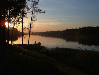 Scenic view of lake against sky during sunset