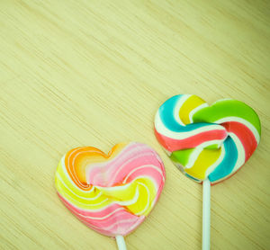 Close-up of colorful heart shape lollipops on table