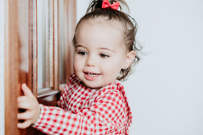 Portrait of cute baby girl against white background