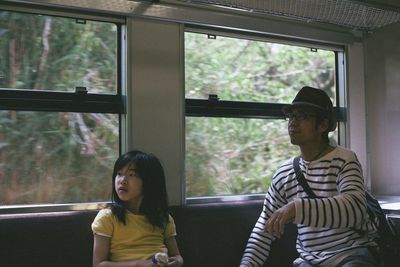 Father and daughter inside the train