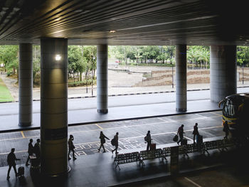 Rear view of people walking at airport