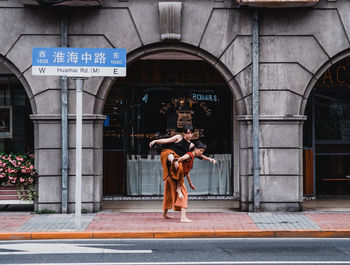 Full length rear view of man standing against building