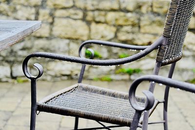 Close-up of empty bench in park