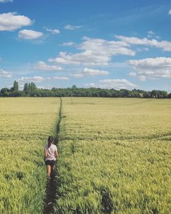 Man standing on field against sky