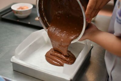 Cropped hand of person washing hands on table