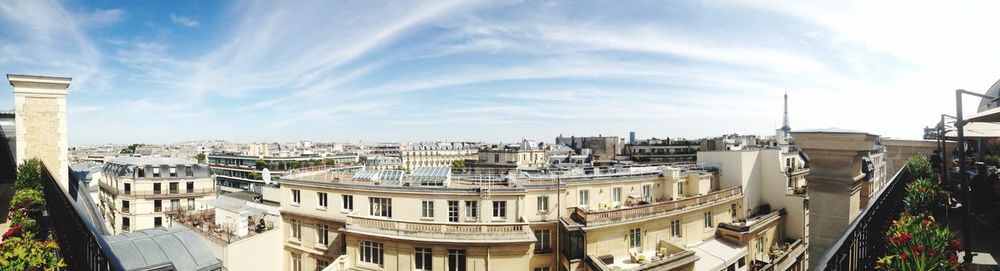 Buildings against cloudy sky