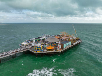 Aerial view of brighton palace pier, with the seafront behind.