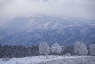 Scenic view of snow covered mountains against sky