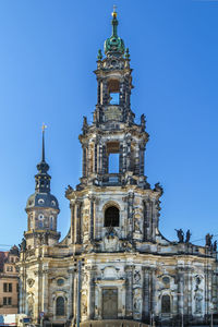 Low angle view of historic building against blue sky