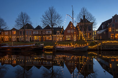 Decorated sailing boats in the harbor from dokkum in friesland the netherlands at sunset