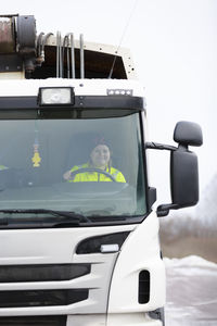 Woman driving garbage truck