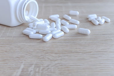 Close-up of white bottles on table