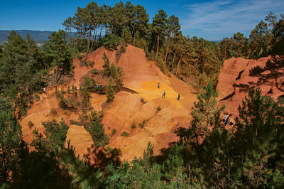 View of ocher land and people in the sentiers des ocres park at roussillon, france.