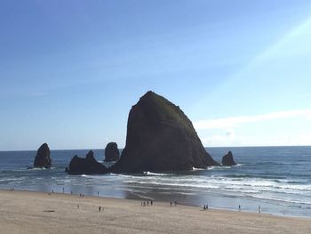 Scenic view of beach against clear blue sky