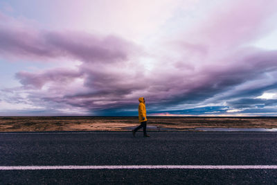 Man standing on land against sky