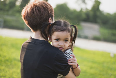 Side view of young woman looking at park