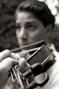 Close-up of man playing guitar