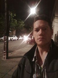 Portrait of man in car at night