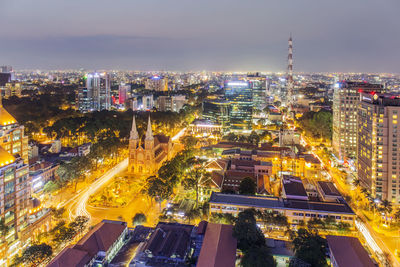 High angle view of city lit up at night