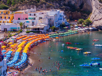 High angle view of people by sea against buildings in city