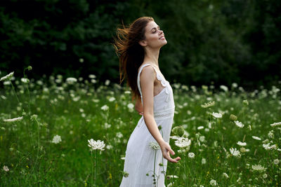 Young woman standing on field