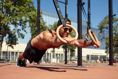 Low angle view of man exercising in park