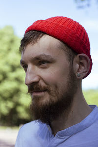 Sailor in a red hat.  with a beard and mustache.