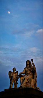 Statue of liberty against cloudy sky