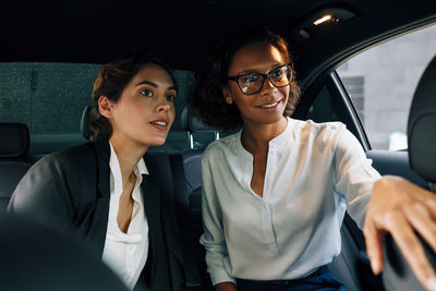 Young woman sitting in car