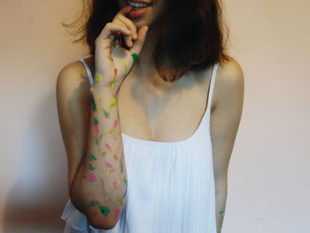 Midsection of woman with paint on hand