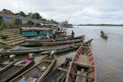 Boats moored in sea against sky