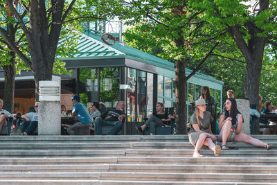 Group of people sitting outside building