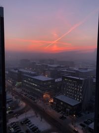 High angle view of illuminated buildings against sky at sunset