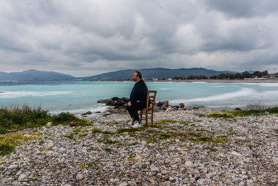 Man standing on beach against sky