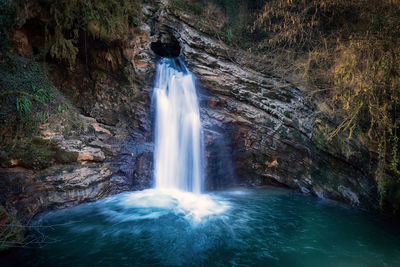 Waterfalls from above through a hole in the rock. the waterfall feeds the aniene river forming.