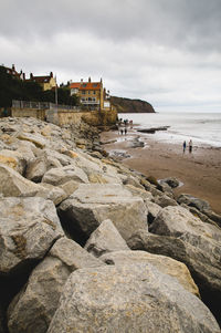 Scenic view of beach against cloudy sky