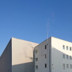 Low angle view of modern building against blue sky