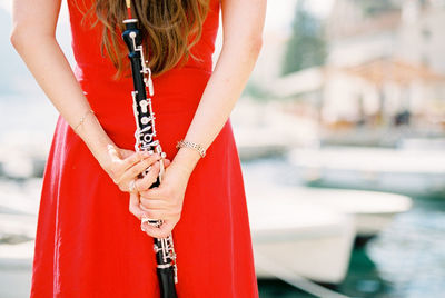 Midsection of woman playing guitar