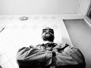 Portrait of man holding sunglasses