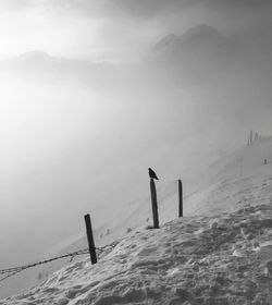 Scenic view of snow covered land against sky