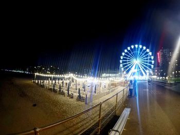 Illuminated ferris wheel at night