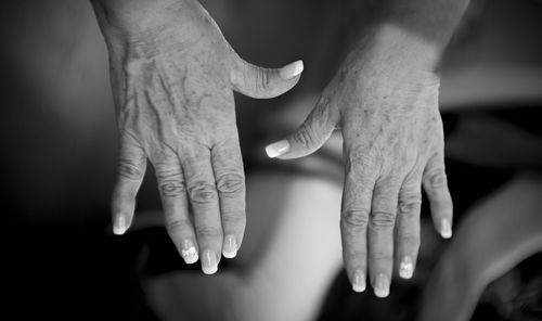 Close-up of cropped hands with nail polish